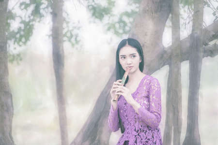 Beautiful Asian girl in Bali traditional costume.の写真素材