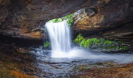 Panoramic photo landscape, Waterfall hidden in the tropical, The beautiful waterfall in forest, The fascinating waterfall in the forest and water flows through a hole.の写真素材