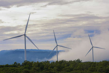 Wind turbines, Eco power and agricultural fields with cloudy day sunset landscapes on the mountain, Energy Production with clean and Renewable Energy. Protection of nature.の写真素材