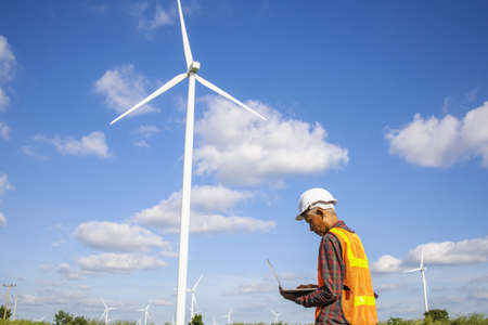 Wind turbines, Eco power and agricultural fields with cloudy day sunset landscapes on the mountain,Energy Production with clean and Renewable Energy. Protection of nature.Wind turbine control engineerの写真素材