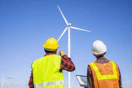 Wind turbines, Eco power and agricultural fields with cloudy day sunset landscapes on the mountain,Energy Production with clean and Renewable Energy. Protection of nature.Wind turbine control engineerの写真素材