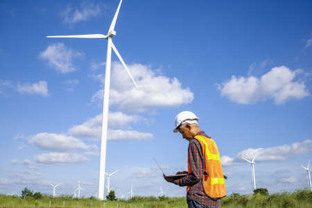 Wind turbines, Eco power and agricultural fields with cloudy day sunset landscapes on the mountain,Energy Production with clean and Renewable Energy. Protection of nature.Wind turbine control engineerの写真素材