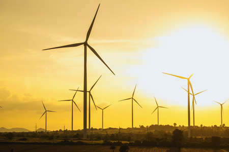 Wind turbines, Eco power and agricultural fields with sunset landscapes , Energy Production with clean and Renewable Energy. Protection of nature.の写真素材