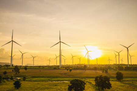 Wind turbines, Eco power and agricultural fields with sunset landscapes , Energy Production with clean and Renewable Energy. Protection of nature.の写真素材