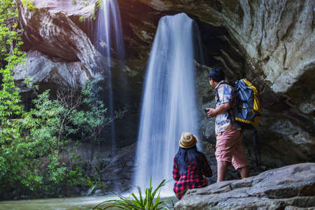 Panoramic photo landscape, Waterfall hidden in the tropical, The beautiful waterfall in forest, The fascinating waterfall in the forest and water flows through a hole.の写真素材