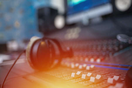 Recording room,Compression room, Music on sound mixer in recording studio.Close Up Shot of Audio Producer Working in Music Recording Studio, Uses Mixing Board Create Modern Song. Sound recording room.の写真素材
