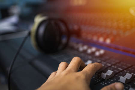 Recording room,Compression room, Music on sound mixer in recording studio.Close Up Shot of Audio Producer Working in Music Recording Studio, Uses Mixing Board Create Modern Song. Sound recording room.の写真素材