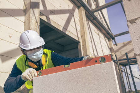 Unpainted lightweight brick wall, Lightweight bricks that are placed together for building walls with in the building, House construction  building site with lightweight bricks.の写真素材