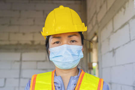Construction workers who are tired from working during the pandemic.の写真素材