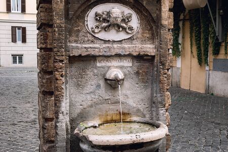 Old traditional drinking fountain with cold water in Rome.