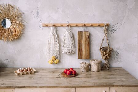 Cooking food on rustic style kitchen interior with furniture in grey color and wooden tabletop....