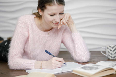 Happy beautiful girl school college student sit on floor, reading a book, distance learn at home...