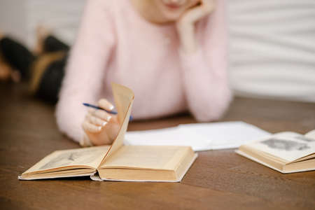 girl sit on floor reading book