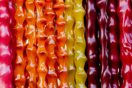 Colorful homemade sweets Churchkhela with hazelnuts, walnuts, grape juice, honey or sugar, wheat or corn flour. Dessert sold in local food market.の写真素材