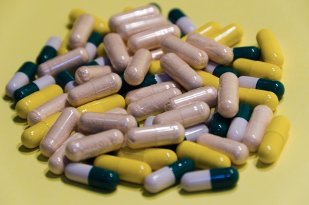 macro shot of yellow beige, green and white vitamine capsulesの写真素材