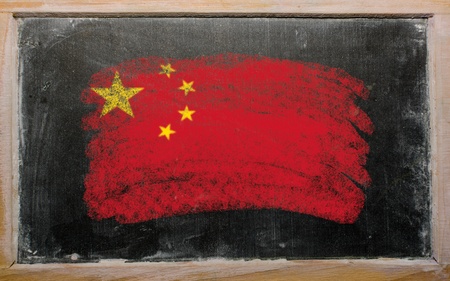 Chalky chinese flag painted with color chalk on old blackboardの写真素材