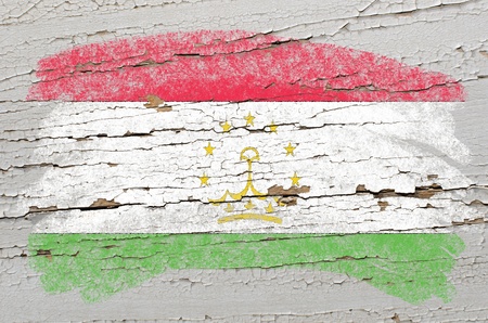 Chalky tajikistan flag painted with color chalk on grunge wooden textureの写真素材