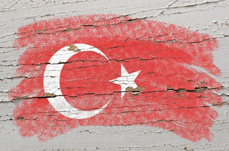 Chalky turkish flag painted with color chalk on grunge wooden textureの写真素材