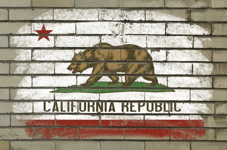 Chalky and grunge american state of california flag painted with color chalk on brick wallの写真素材