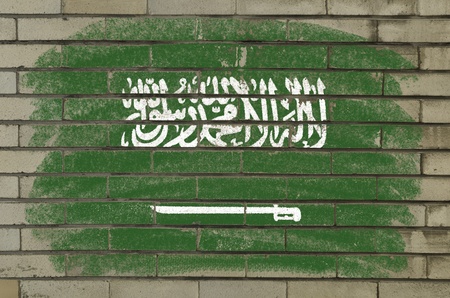 Chalky and grunge saudi arabia flag painted with color chalk on brick wallの写真素材