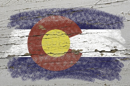 Chalky american state of colorado flag precisely painted with color chalk on grunge wooden textureの写真素材