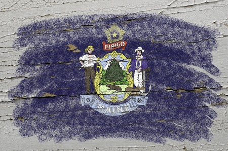 Chalky american state of maine flag precisely painted with color chalk on grunge wooden textureの写真素材