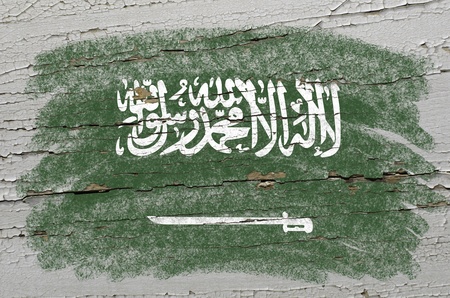 Chalky saudi arabia flag precisely painted with color chalk on grunge wooden textureの写真素材