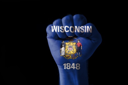 Low key picture of a fist painted in colors of american state flag of wisconsinの写真素材