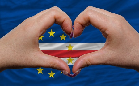 Gesture made by hands showing symbol of heart and love over flag of cape verdeの写真素材