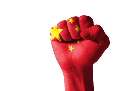 Low key picture of a fist painted in colors of china flagの写真素材