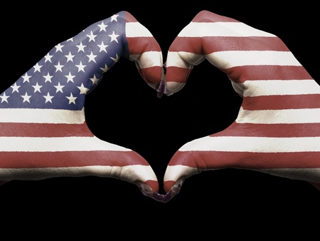 Tourist gesture made by america flag colored hands showing symbol of heart and love の写真素材