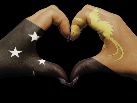Tourist made gesture  by papua new guinea flag colored hands showing symbol of heart and love の写真素材