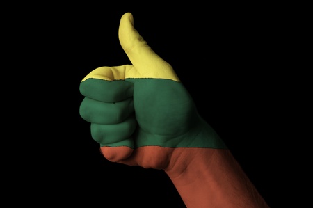 Hand with thumb up gesture in colored lithuania national flag as symbol of excellence, achievement, good, - useful for tourism and touristic advertising and also current positive political, cultural, social management of state or countryの写真素材