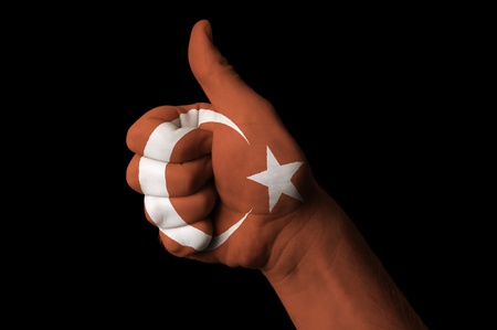 Hand with thumb up gesture in colored turkey national flag as symbol of excellence, achievement, good, - useful for tourism and touristic advertising and also current positive political, cultural, social management of state or countryの写真素材