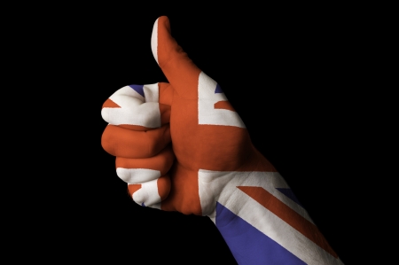 Hand with thumb up gesture colored in great britain national flag as symbol of excellence, achievement, good, - useful for tourism and touristic advertising and also current positive political, cultural, social management of state or countryの写真素材