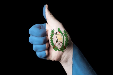 Hand with thumb up gesture in colored guatemala national flag as symbol of excellence, achievement, good, - for tourism and touristic advertising, positive political, cultural, social management of countryの写真素材