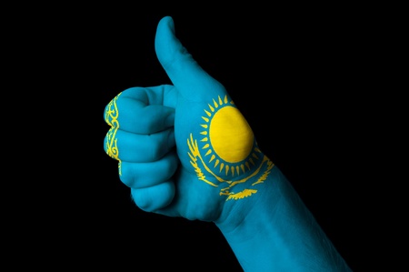 Hand with thumb up gesture in colored kazakhstan national flag as symbol of excellence, achievement, good, - for tourism and touristic advertising, positive political, cultural, social management of countryの写真素材