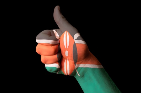 Hand with thumb up gesture in colored kenya national flag as symbol of excellence, achievement, good, - for tourism and touristic advertising, positive political, cultural, social management of countryの写真素材