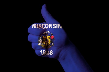 Hand with thumb up gesture in colored wisconsin usa state flag as symbol of excellence, achievement, good, - for tourism and touristic advertising, positive political, cultural, social management of countryの写真素材
