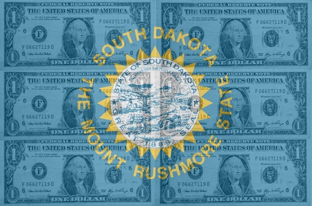 transparent united states of america state flag of south dakota with dollar currency in background symbolizing political, economical and social governmentの写真素材