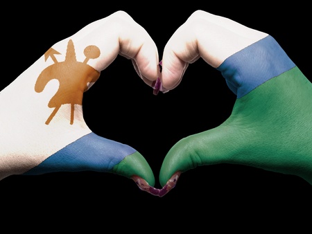 Tourist made gesture  by lesotho flag colored hands showing symbol of heart and loveの写真素材