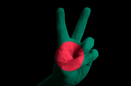 Hand with two finger up gesture in colored bangladeshi national flag as symbol of winning, victorious, excellent, - for tourism and touristic advertising, positive political, cultural, social management of countryの写真素材