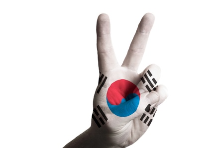 Hand with two finger up gesture in colored south korea national flag as symbol of winning,...