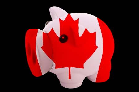 piggy rich bank in colorsnational flag of canadafor saving money on black backgroundの写真素材