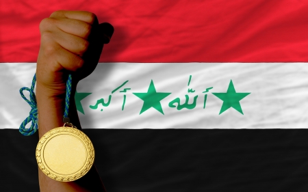 Winner holding gold medal for sport and national flag of iraqの写真素材