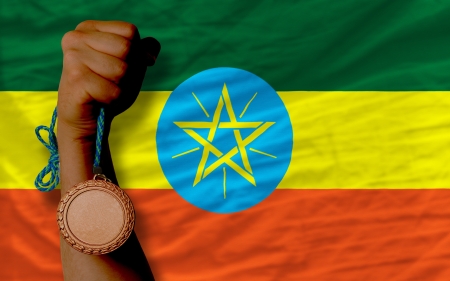 Holding bronze medal for sport and national flag of ethiopiaの写真素材