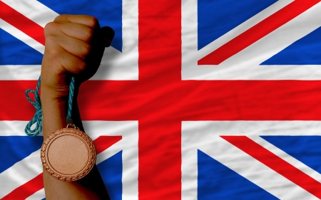 Holding bronze medal for sport and national flag of ukの写真素材