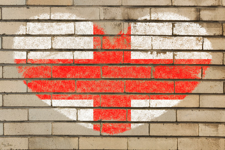 heart shaped flag in colors of england on brick wallの写真素材