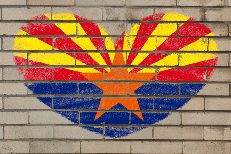 heart shaped flag in colors of arizona on brick wallの写真素材