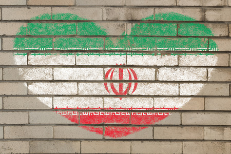 heart shaped flag in colors of iran on brick wallの写真素材